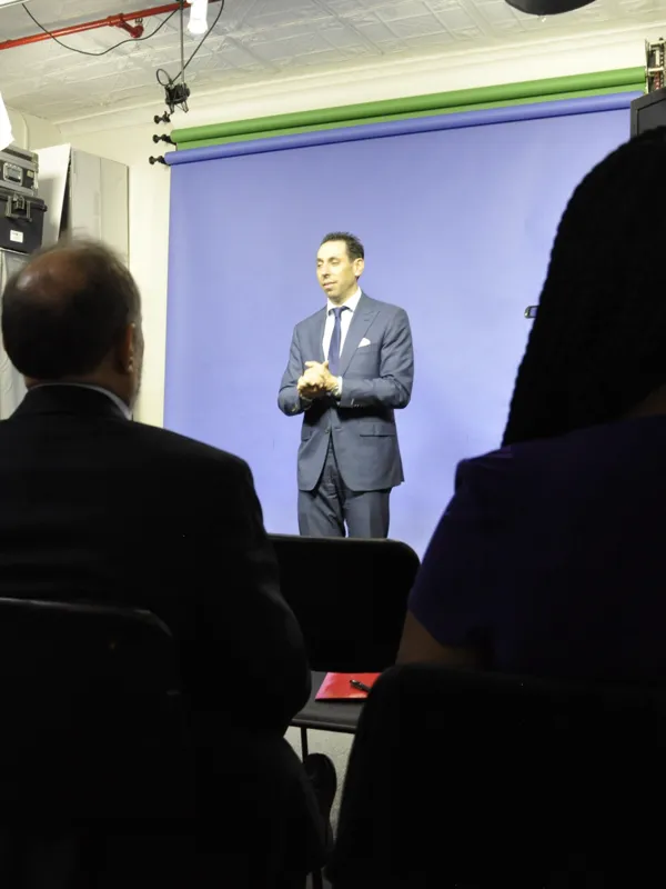 Jess Todtfeld standing in front of a small group during a presentation training session, speaking to the room directly