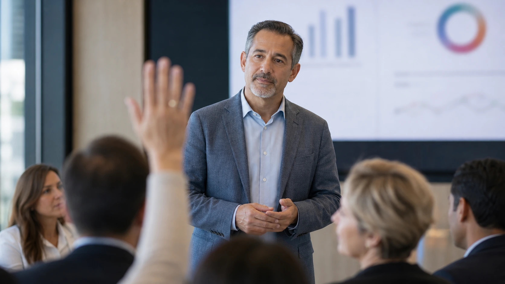 A leader listening closely to a question from someone across a conference table