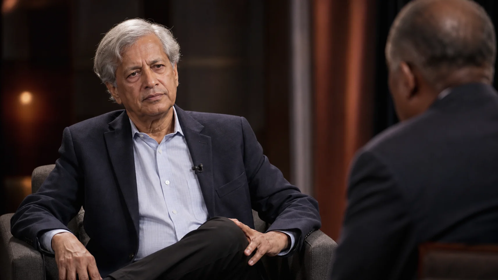 A senior executive being interviewed on camera in a television studio