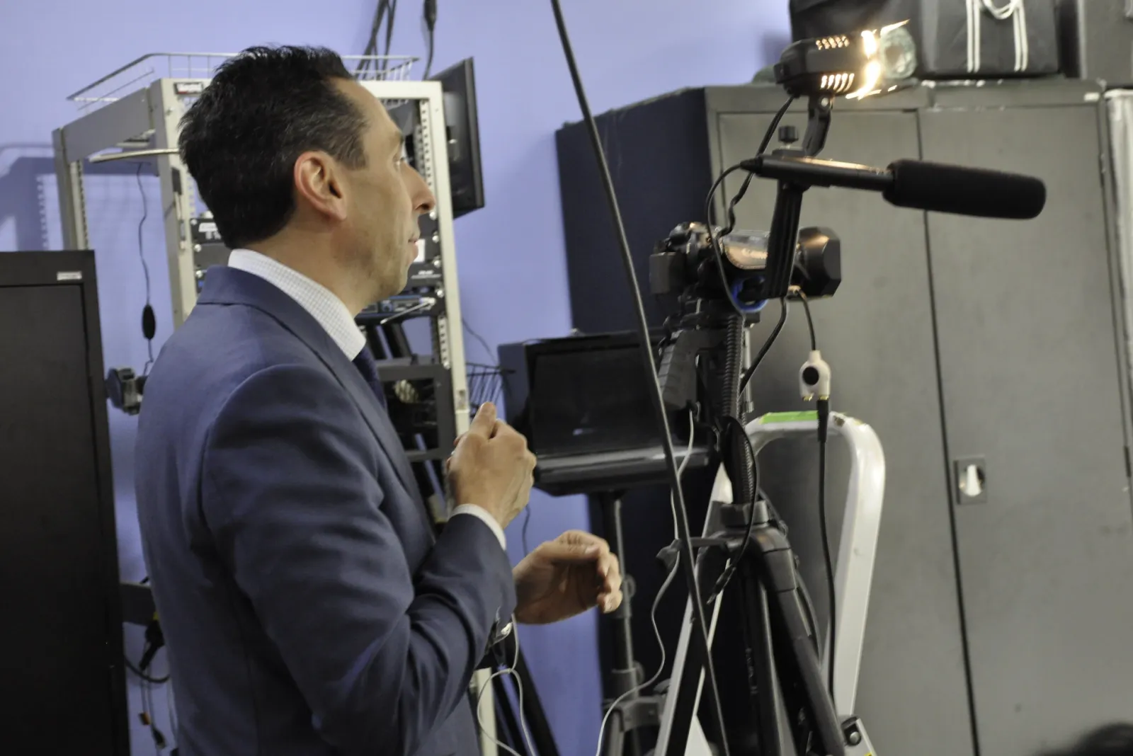 A media training session under way in a studio, with a camera and microphone set up to record the client on camera