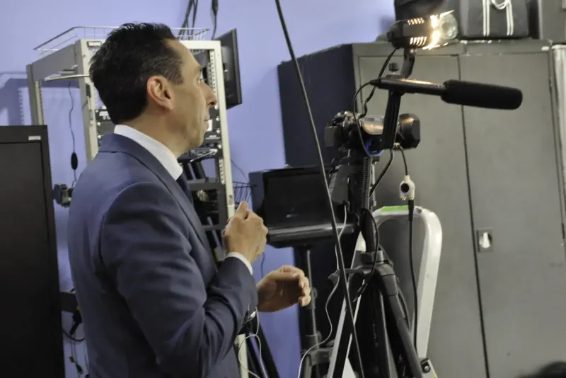 Jess Todtfeld setting up a camera and shotgun microphone for a training session