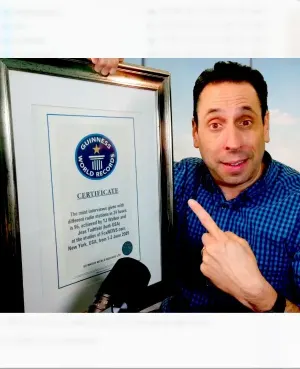 Jess Todtfeld holding his framed Guinness World Record certificate
